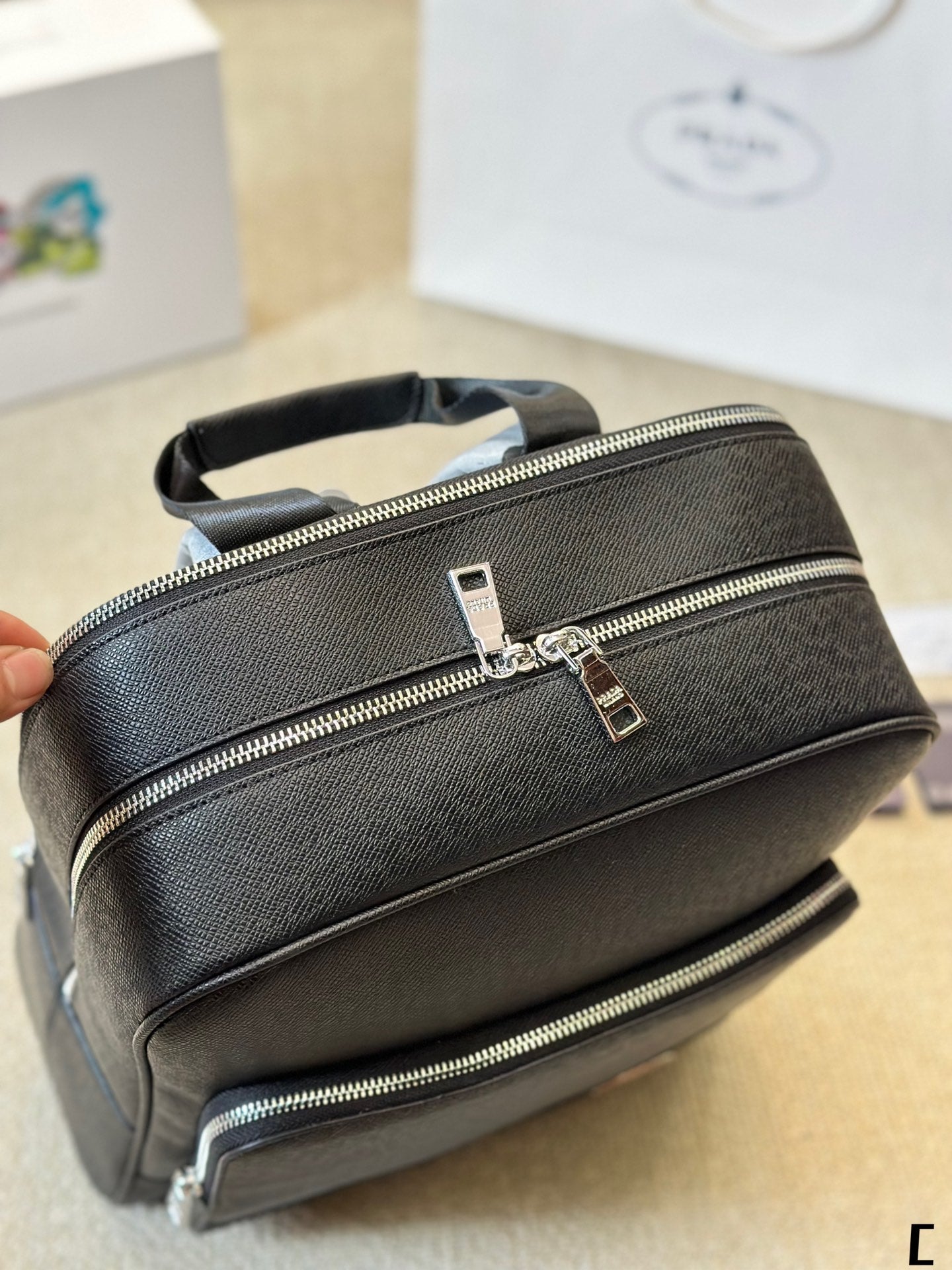 FRONT ZIP POCKET BACKPACK 38 IN BLACK GRAINED CALFSKIN